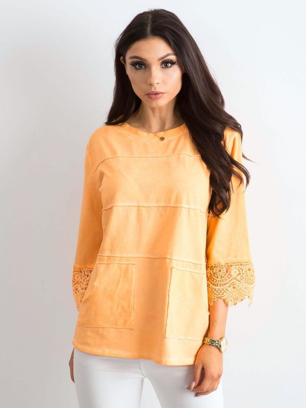 Orange blouse with lace and pockets