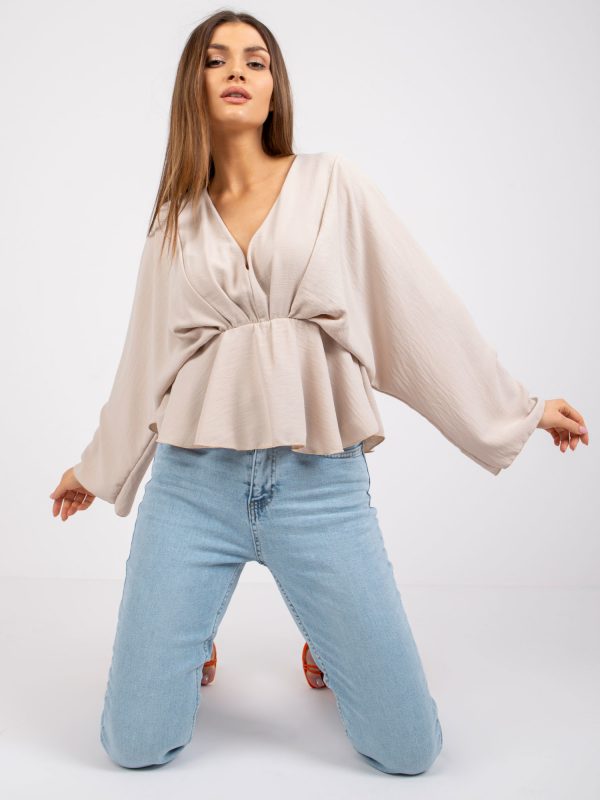 Raquel's light beige triangular neckline blouse