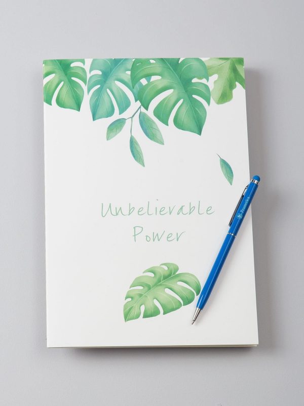 White notebook in exotic leaves