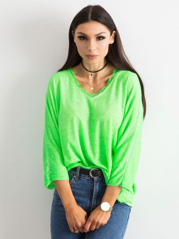 Fluo green blouse with lace at the neckline