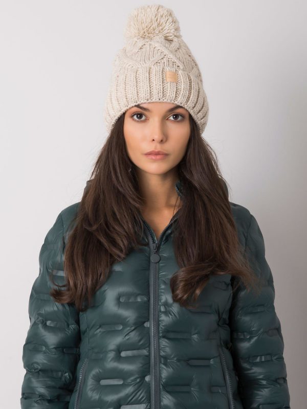 Beige winter hat with pompom