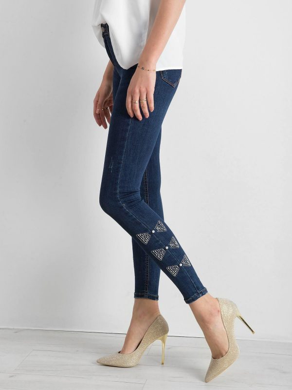 Blue denim pants with applique on the legs