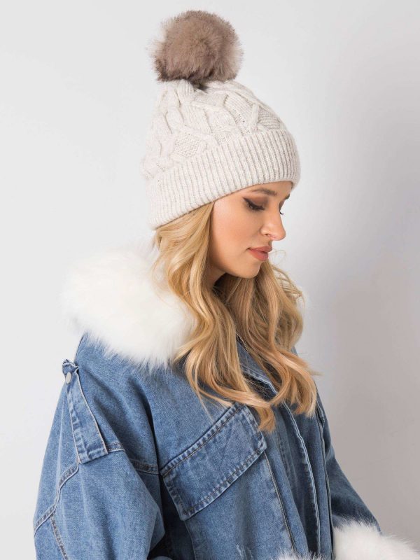 Beige hat for winter with pompom