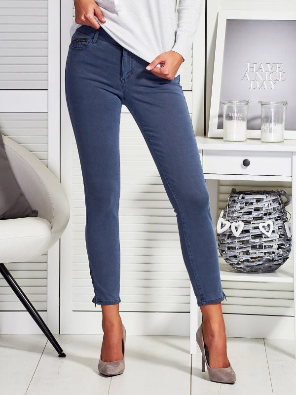 Gray trousers with sliders on the legs