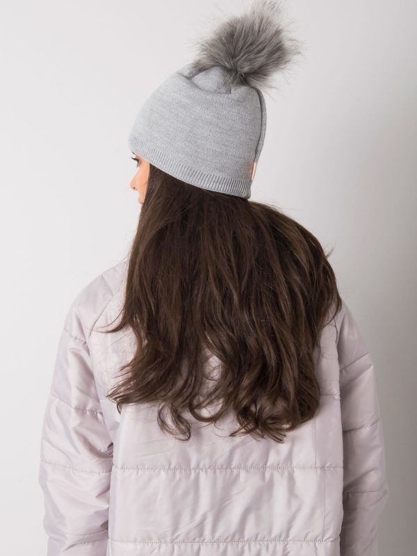 Grey padded women's hat with tassel