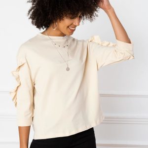 Sarah's light beige blouse