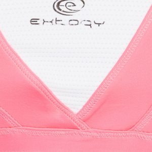 Fluoride pink sports top with crisscrossed shoulder straps on the back