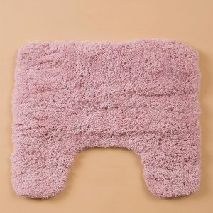 Pink bathroom mat under toilet